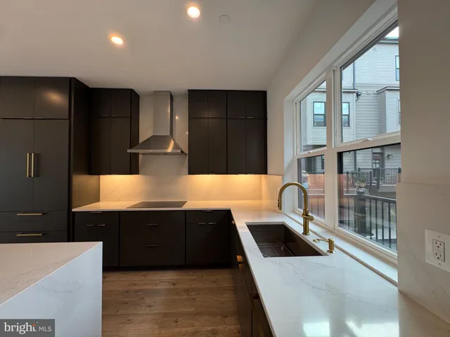 a kitchen with stainless steel appliances a sink stove and refrigerator