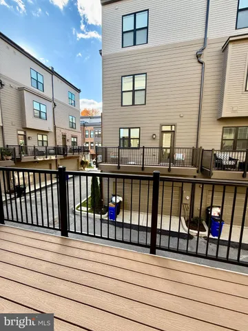 a view of a balcony with wooden floor and fence