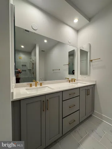 a bathroom with a double vanity sink and a mirror