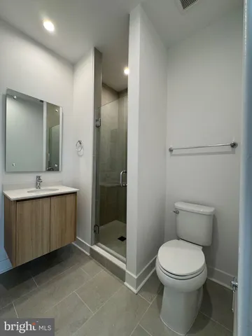 a bathroom with a toilet a sink and shower