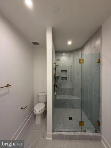 a bathroom with a shower and a toilet