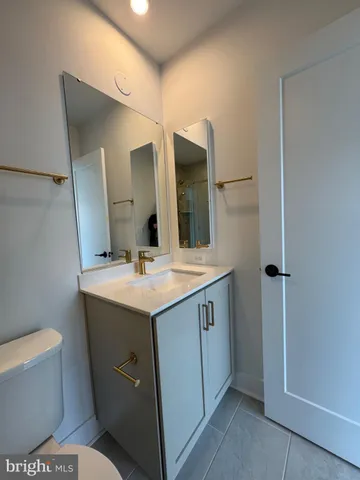 a bathroom with a double vanity sink and mirror