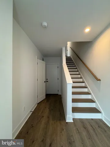 a view of an entryway with wooden floor