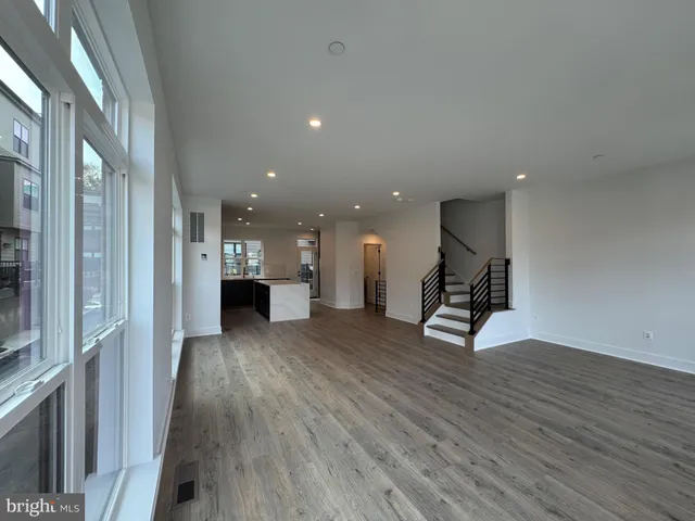 a view of a living room with wooden floor and a window