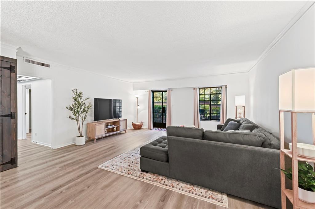 3648 Peachtree Road Northeast, Unit 1A Atlanta, GA 30319 - Photo 11 of 36 a living room with furniture and a flat screen tv