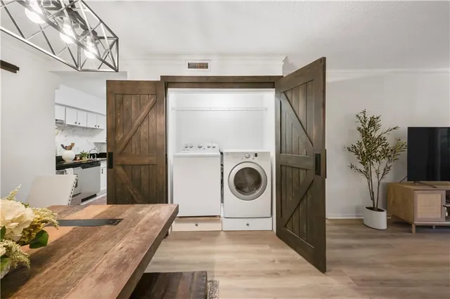 a kitchen with a refrigerator and a stove top oven
