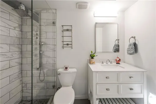 a bathroom with a sink toilet and shower