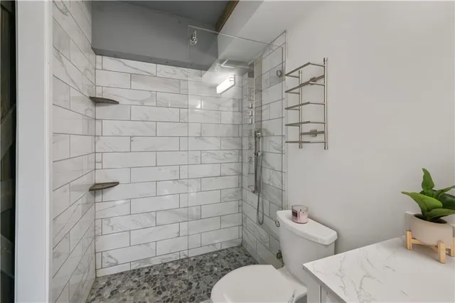 a bathroom with a toilet and shower