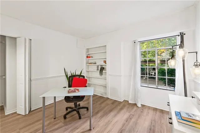 a workspace with furniture wooden floor and windows