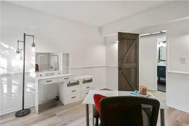 a bedroom with a bed and a refrigerator