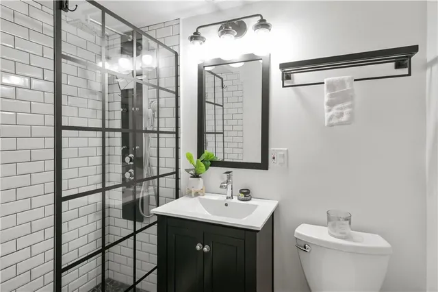 a bathroom with a shower sink and mirror