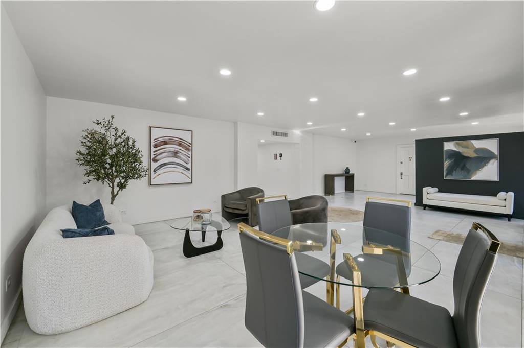 3648 Peachtree Road Northeast, Unit 1A Atlanta, GA 30319 - Photo 25 of 36 a living room with couches and kitchen view with wooden floor
