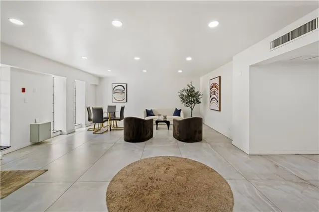 a lobby with furniture and a rug