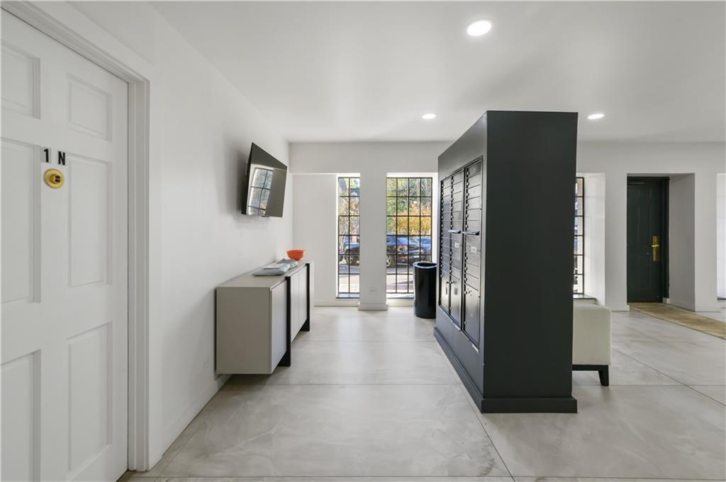 3648 Peachtree Road Northeast, Unit 1A Atlanta, GA 30319 - Photo 27 of 36 a view of a hallway with living room and furniture