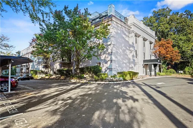 a front view of a house with a yard and fountain