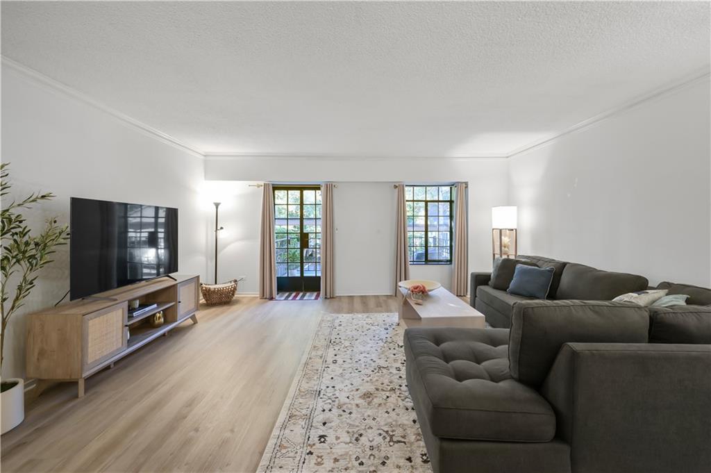 3648 Peachtree Road Northeast, Unit 1A Atlanta, GA 30319 - Photo 4 of 36 a living room with furniture and a flat screen tv