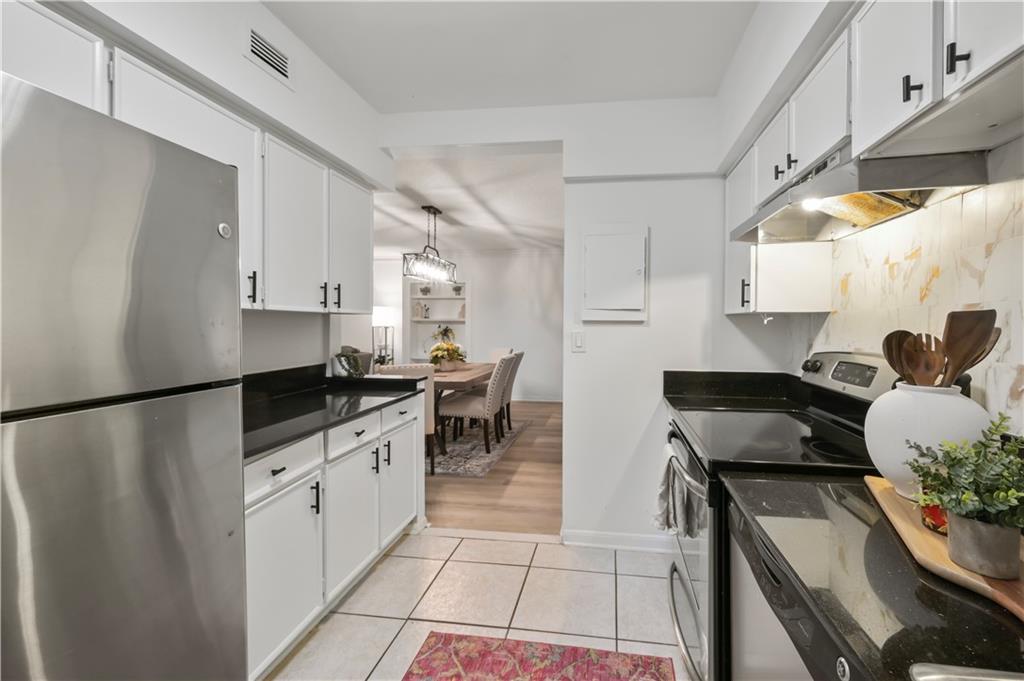 3648 Peachtree Road Northeast, Unit 1A Atlanta, GA 30319 - Photo 8 of 36 a kitchen with granite countertop a sink appliances and cabinets