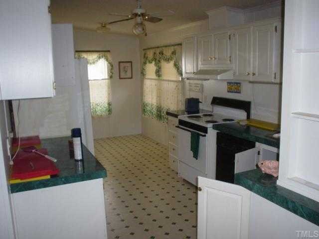 12261 Selma Road Middlesex, NC 27557 - Photo 3 of 6 a kitchen with a stove a refrigerator and a sink