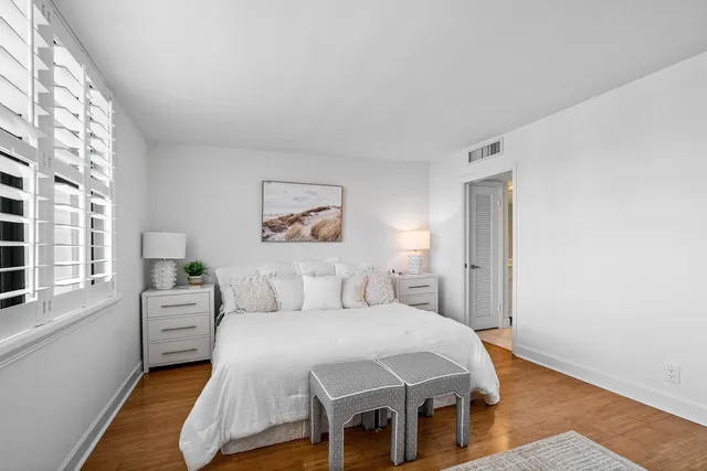 a bathroom with a granite countertop sink mirror and a toilet