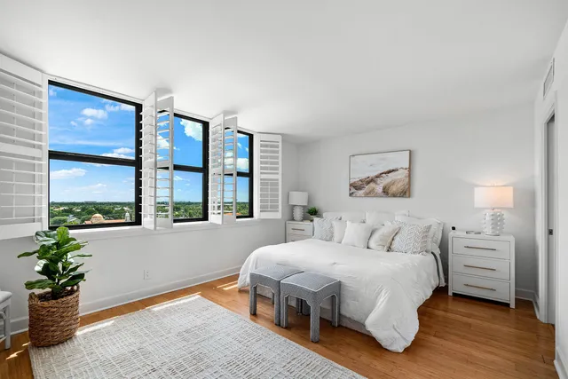 a bedroom with a bed window and dresser