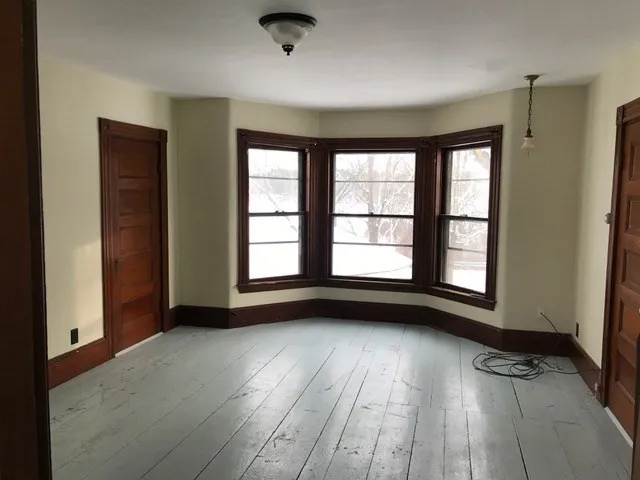 a view of living room with furniture and wooden floor