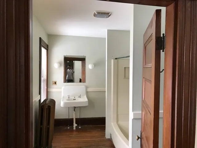 a view of a kitchen with wooden floor and staircase