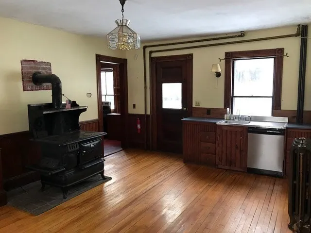 a white toilet sitting next to a wooden cabinet