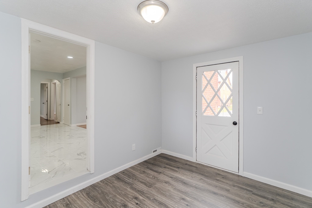 100 Pine Street Ludlow, MA 01056 - Photo 16 of 29 an empty room with wooden floor and windows