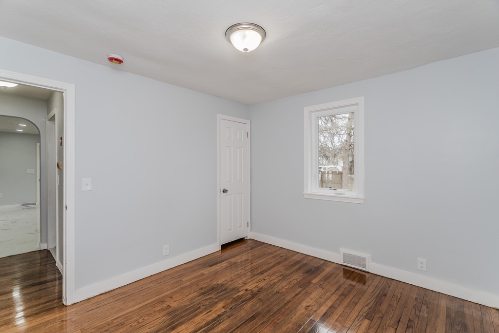 100 Pine Street Ludlow, MA 01056 - Photo 22 of 29 an empty room with wooden floor and windows