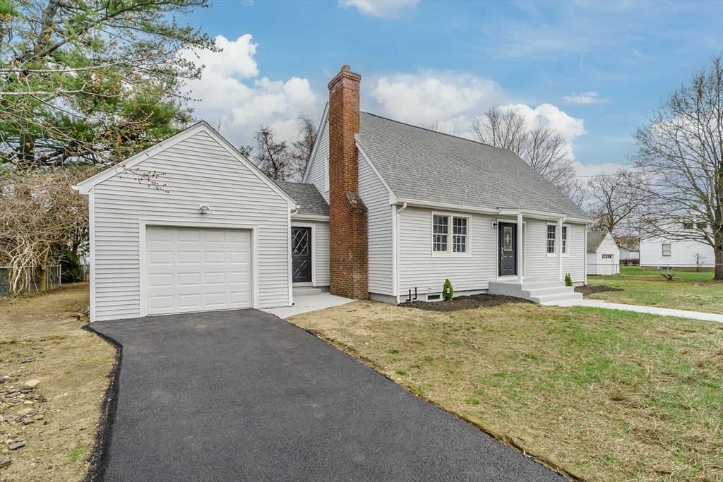 100 Pine Street Ludlow, MA 01056 - Photo 4 of 29 a view of a house with a yard and garage