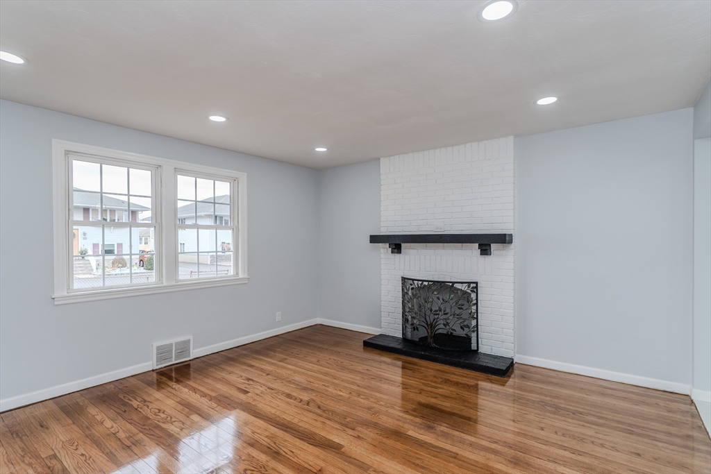 100 Pine Street Ludlow, MA 01056 - Photo 7 of 29 a view of empty room with wooden floor and fireplace