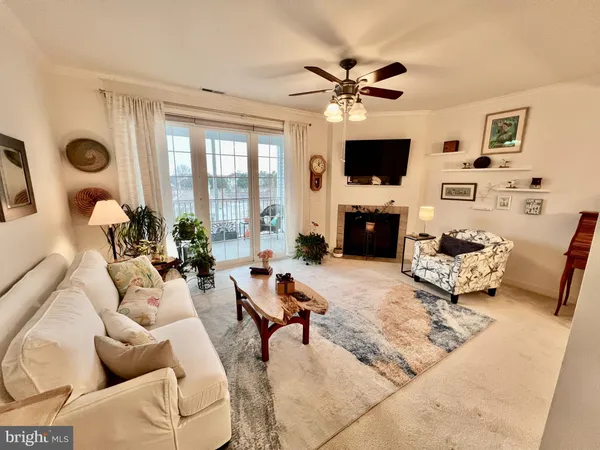 a living room with furniture a flat screen tv and a large window