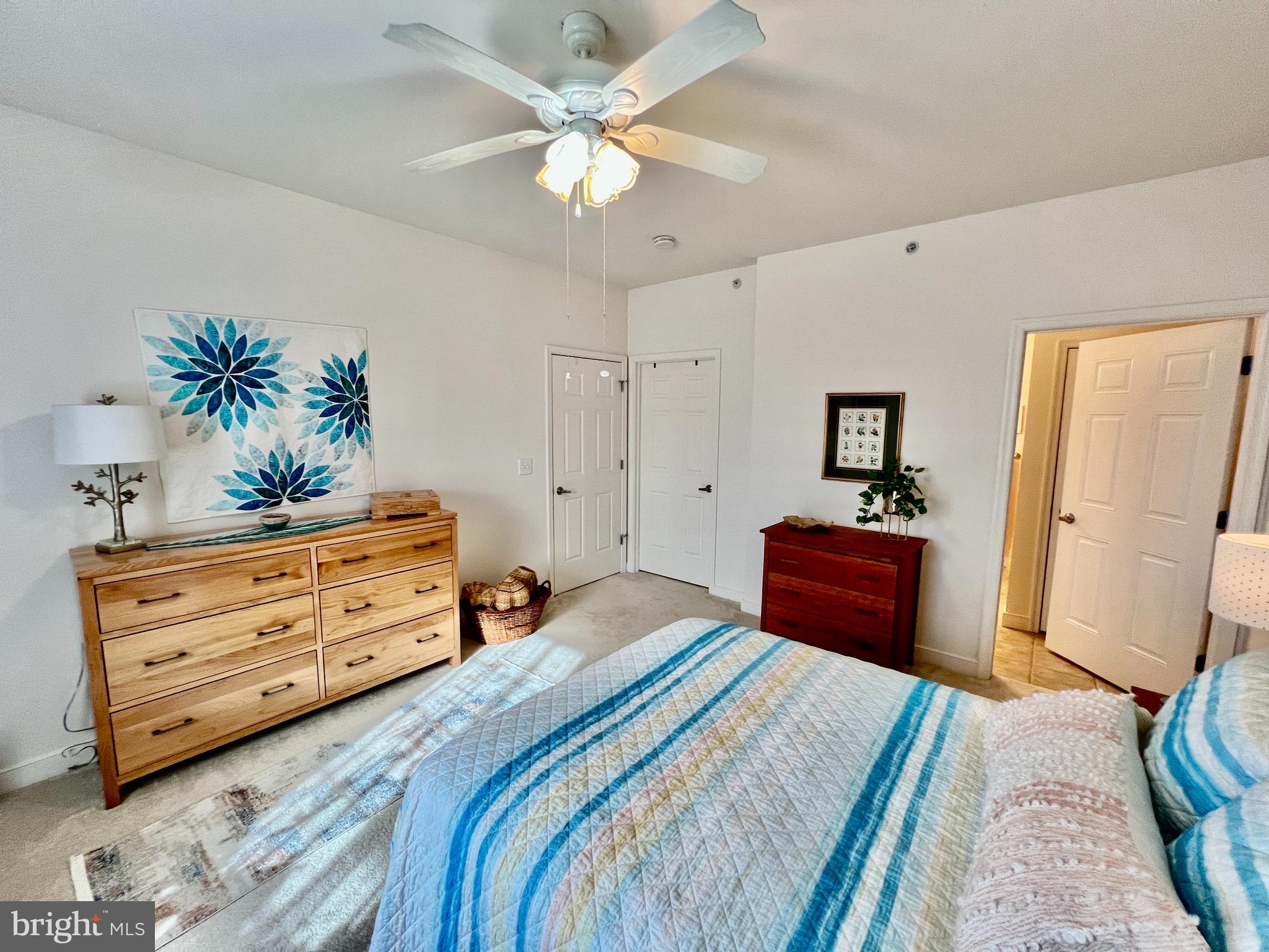30611 Cedar Neck Road, Unit 2306 Ocean View, DE 19970 - Photo 14 of 37 a bedroom with a bed and a dresser