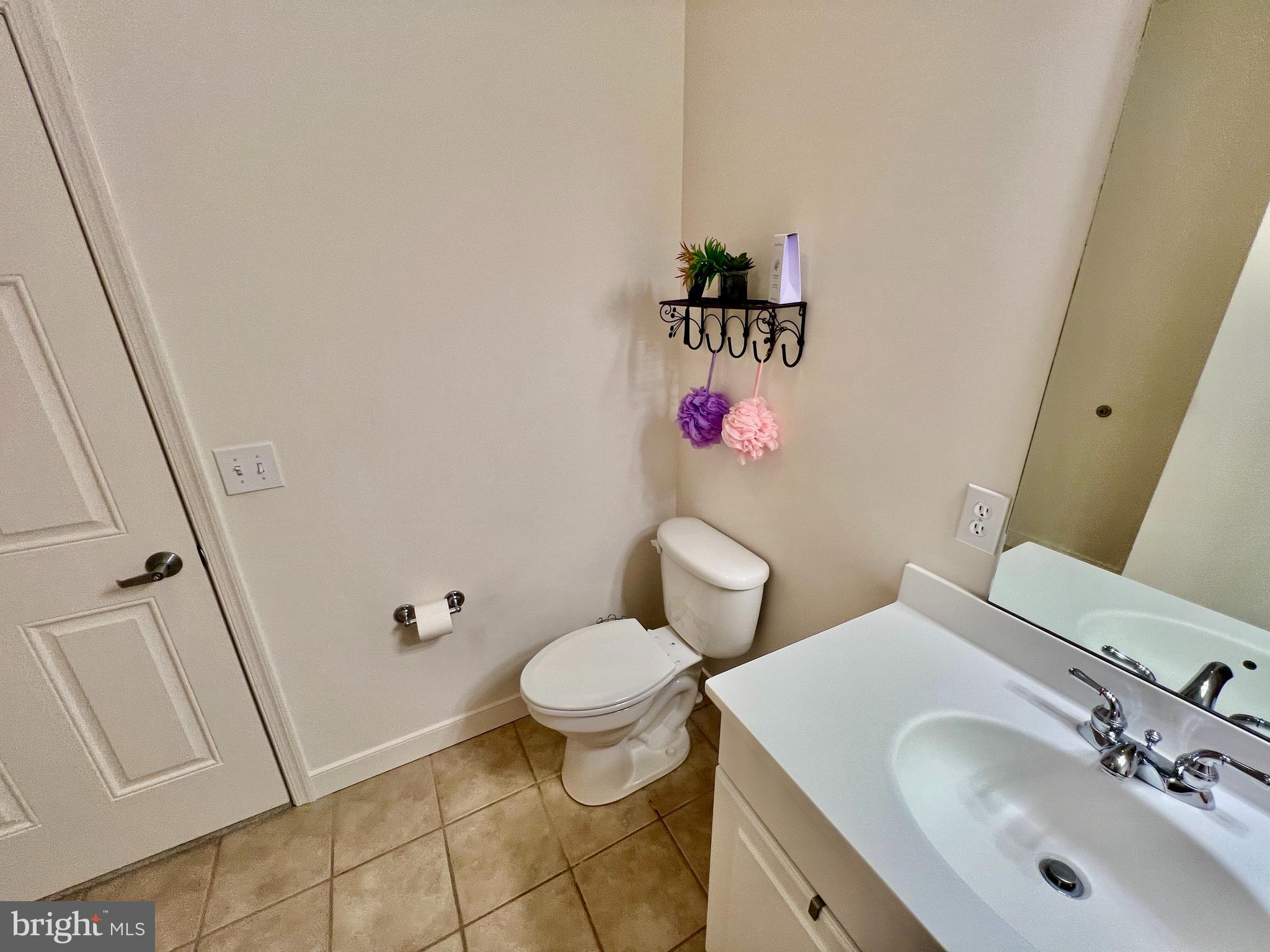 30611 Cedar Neck Road, Unit 2306 Ocean View, DE 19970 - Photo 20 of 37 a bathroom with a sink and a mirror