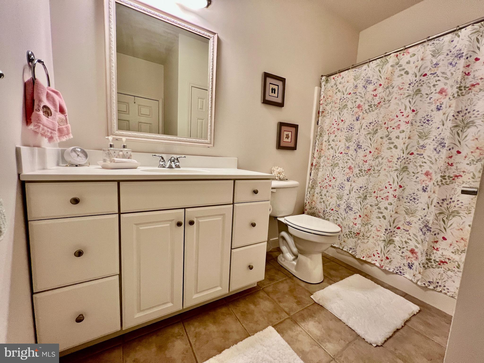 30611 Cedar Neck Road, Unit 2306 Ocean View, DE 19970 - Photo 24 of 37 a spacious bathroom with a toilet sink and mirror