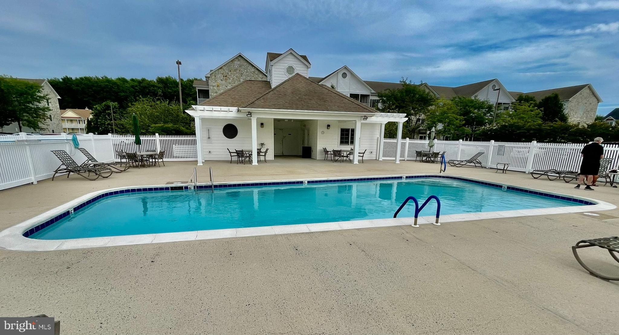 30611 Cedar Neck Road, Unit 2306 Ocean View, DE 19970 - Photo 33 of 37 swimming pool view with a seating space and a garden view
