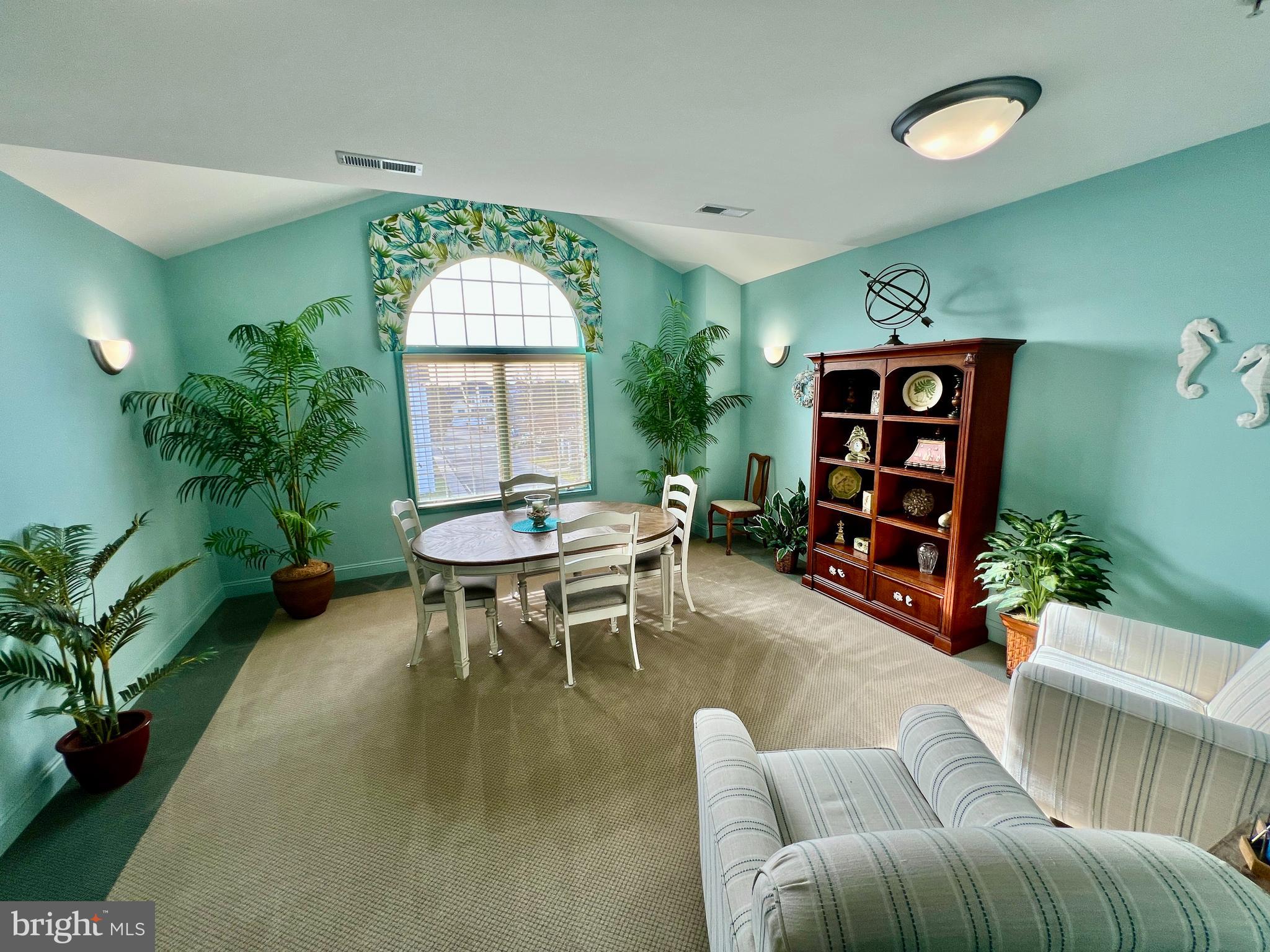 30611 Cedar Neck Road, Unit 2306 Ocean View, DE 19970 - Photo 36 of 37 a living room with furniture a window and a table