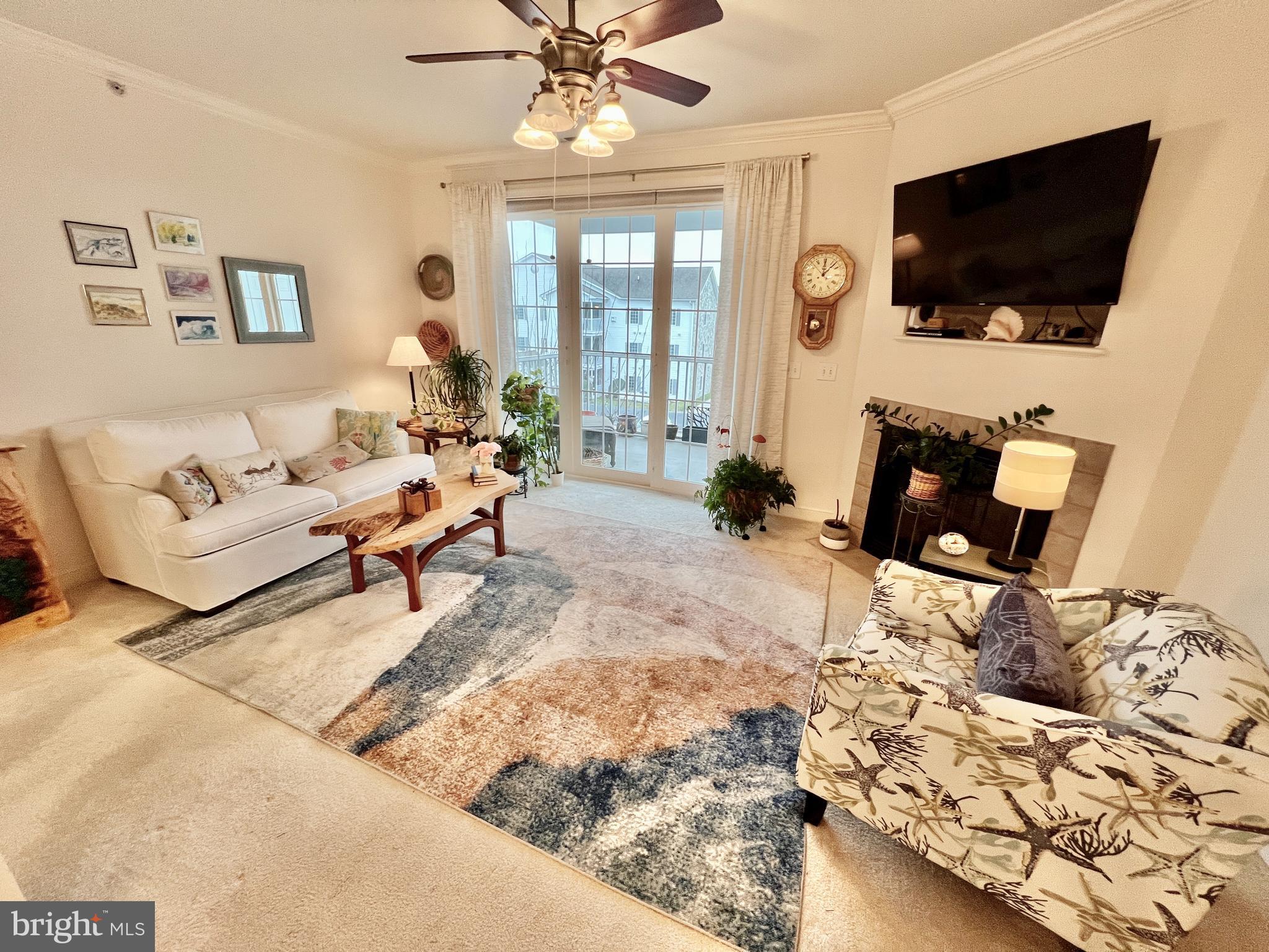 30611 Cedar Neck Road, Unit 2306 Ocean View, DE 19970 - Photo 4 of 37 a living room with furniture and a flat screen tv