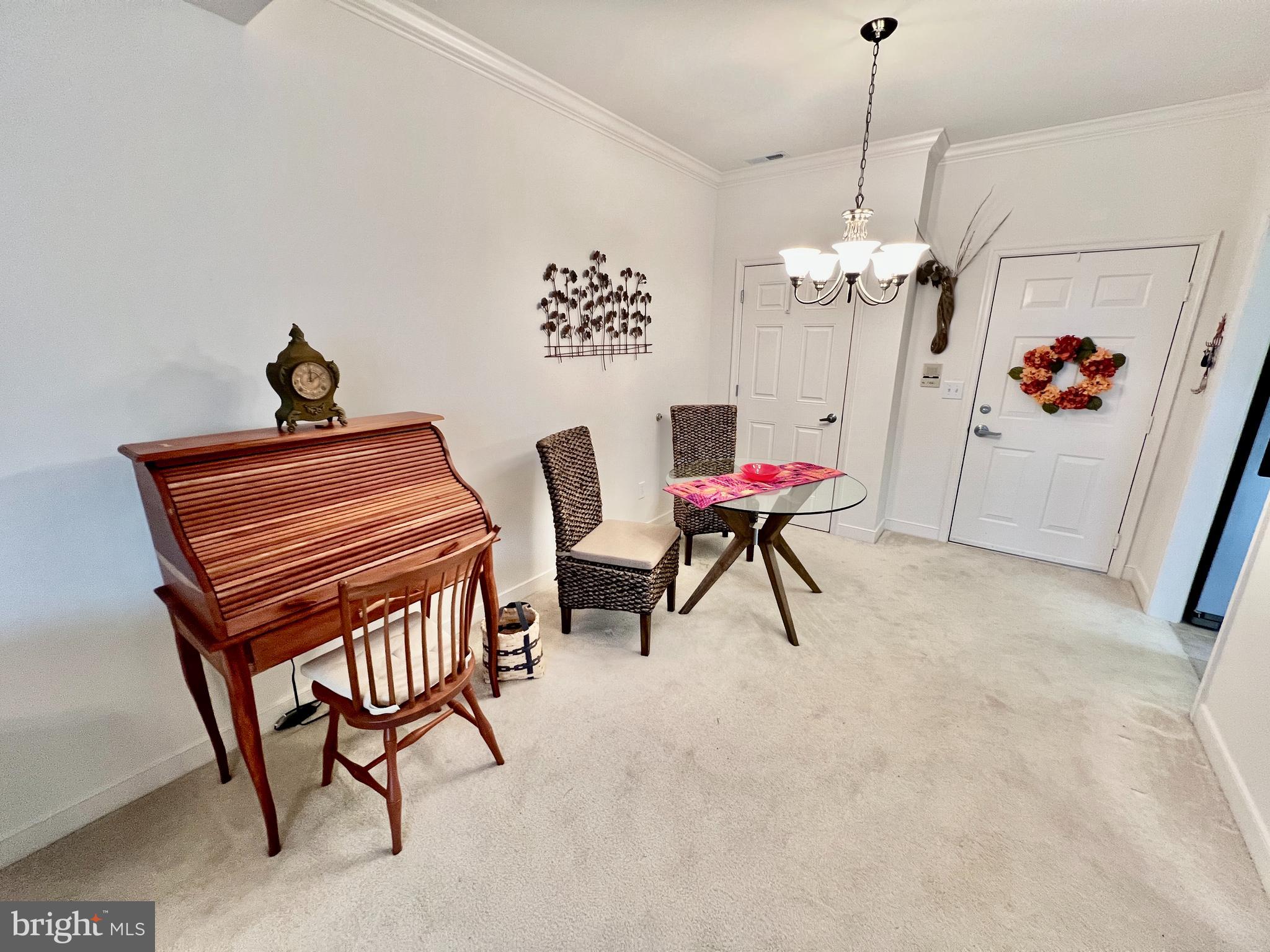30611 Cedar Neck Road, Unit 2306 Ocean View, DE 19970 - Photo 7 of 37 a view of a livingroom with furniture and a chandelier