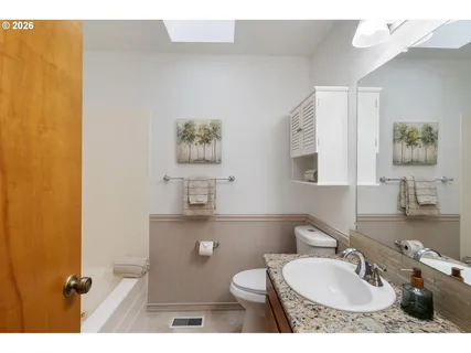 a bathroom with a sink a toilet and a mirror