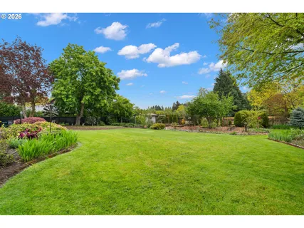 a view of house with a big yard