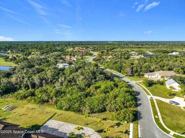 an aerial view of residential houses with outdoor space and swimming pool
