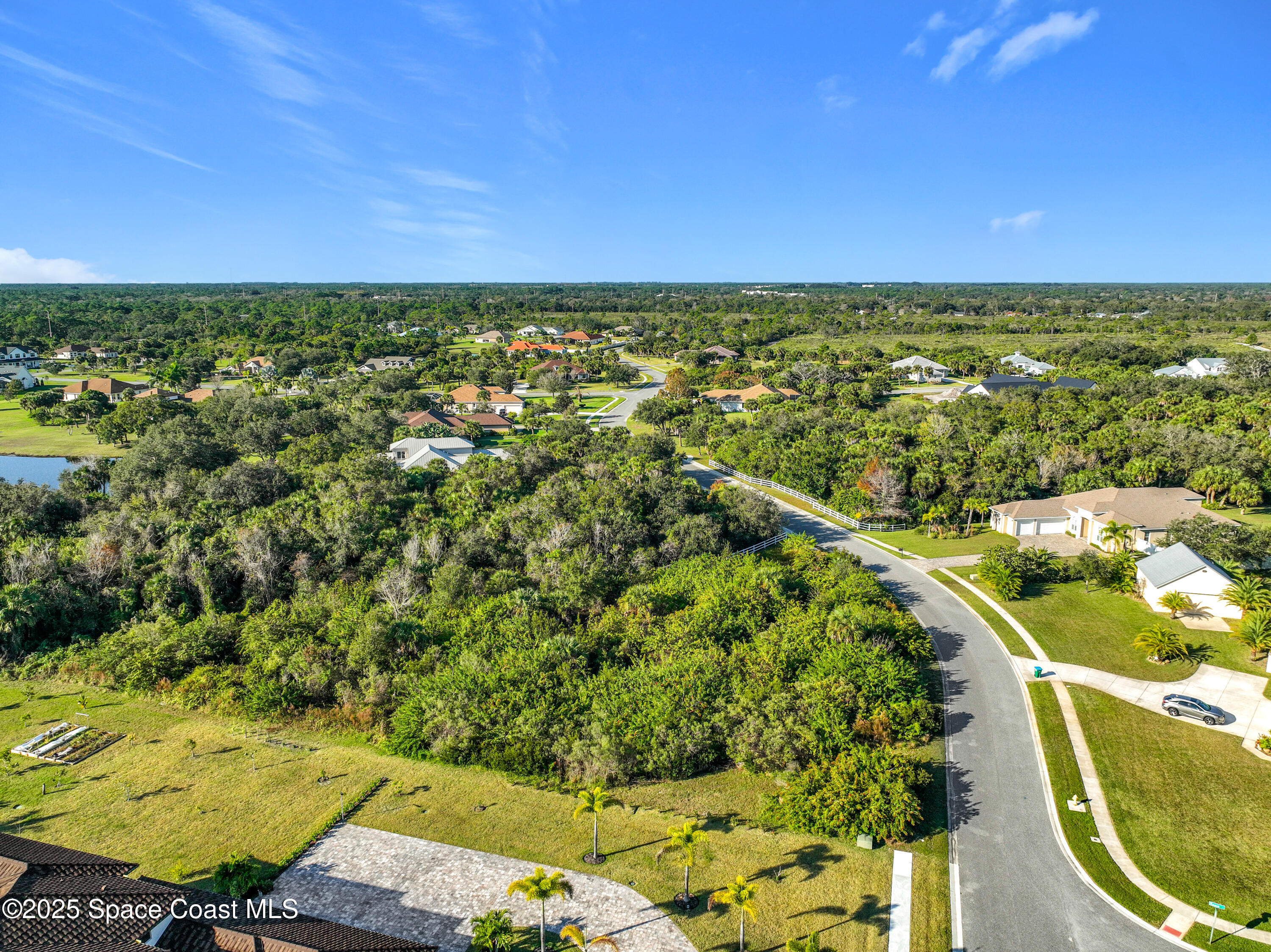 1495 Absaroka Lane Malabar, FL 32950 - Photo 13 of 16 an aerial view of residential houses with outdoor space and swimming pool
