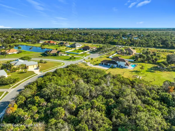 a view of a city with lots of residential buildings ocean and mountain view in back