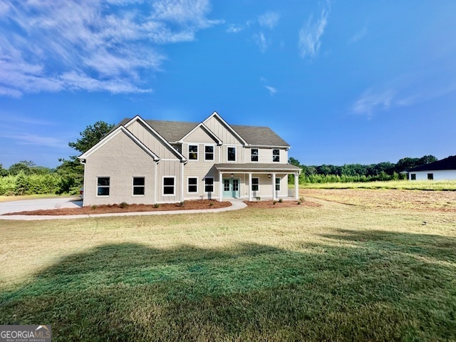 a view of a house with a big yard and a large pool table and chairs