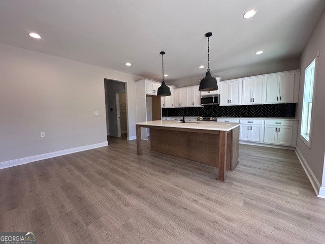 3647 Youngs Mill Road Hogansville, GA 30230 - Photo 11 of 34 a kitchen with kitchen island a sink and a stove