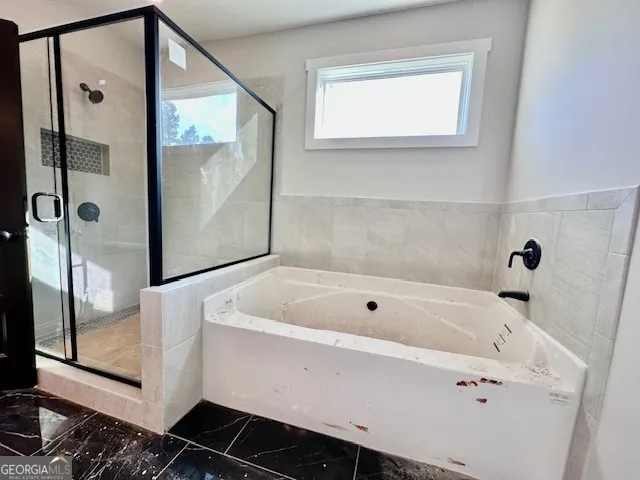 a bathroom with a tub and a shower