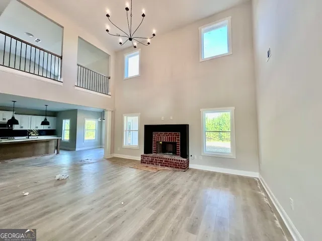 an empty room with windows and a fireplace