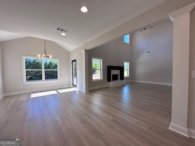 3647 Youngs Mill Road Hogansville, GA 30230 - Photo 7 of 34 an empty room with wooden floor fireplace and windows