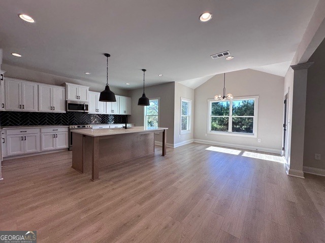 3647 Youngs Mill Road Hogansville, GA 30230 - Photo 8 of 34 a large kitchen with cabinets and wooden floor